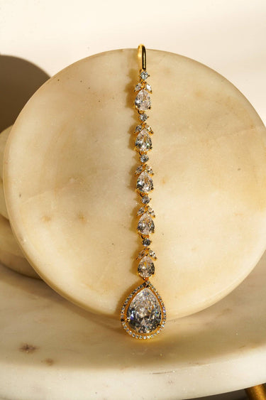 Nila Diamanté Accent Golden AD Maang Tikka - Gold-plated with teardrop stones and diamante accents, available in gold & multicolor or gold & white.