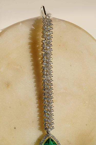 Safi - Rhodium-plated maang tikka with white American Diamonds and a sapphire blue teardrop accent from Inaury