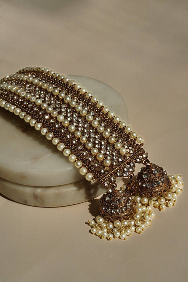 Artisan-crafted Samia Bangles with pearl and CZ embellishments, gold base, and dual jhumkas, ideal for traditional occasions.