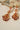 Red stone Sanjana Jewelry Set with gold detailing and pearl drops, blending Indian and Pakistani jewelry traditions.