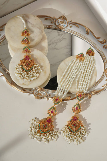 Elegant Sanjana Earrings & Tikka Set with layered pearl strands and multicolor stones, perfect for weddings and ethnic occasions.