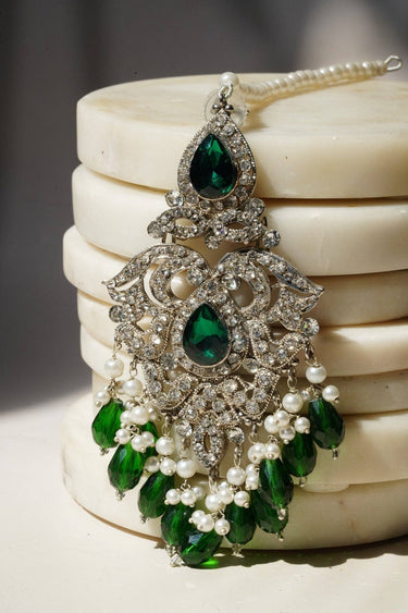 Close-up of Sidra Chandelier Earrings in silver with green CZ stones and faux pearls, perfect for festive or formal wear under $100.