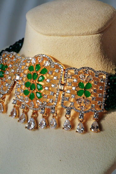 Detailed view of Sumra Choker Necklace Set showing green floral center and teardrop cubic zirconia. Luxurious accessory for special occasions.