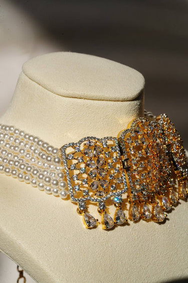 Side view of Sumra Choker Necklace Set with layered pearl strands and gold detailing. Sophisticated accessory for festive wear.