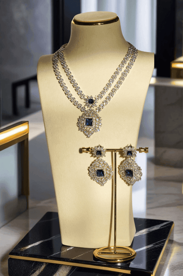 Zeenat Double Layer Diamanté Accent Necklace Set - Rhodium-plated silver finish with intricate detail-cut stones, available in four colors: sapphire blue, emerald green, white, and ruby. Includes matching statement earrings.