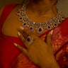 Close-up of pink Purvi Diamante Necklace Set - Bridal Indian Jewelry worn with red saree, showcasing intricate bridal craftsmanship.