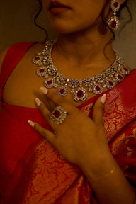 Close-up of pink Purvi Diamante Necklace Set - Bridal Indian Jewelry worn with red saree, showcasing intricate bridal craftsmanship.