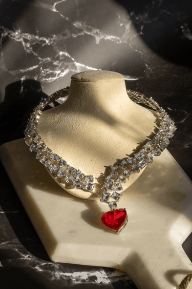 Panache Y-drop necklace set with heart-cut pendant and crystal accents, available in emerald, sapphire, or maroon with matching earrings.