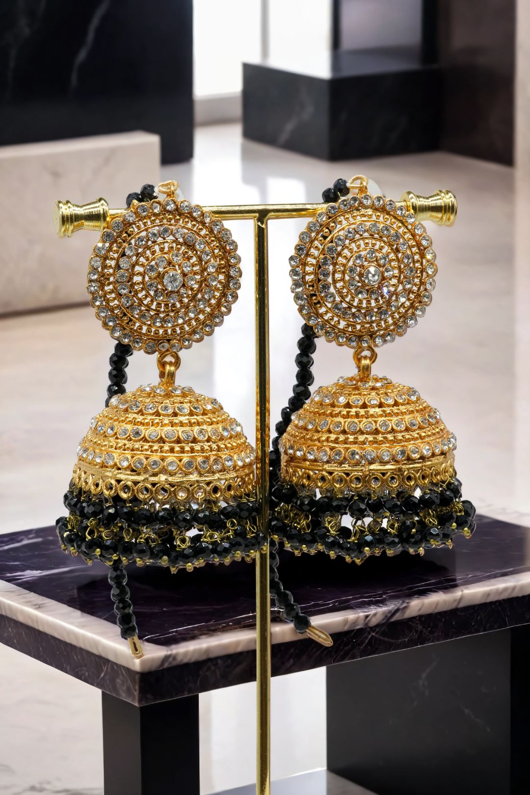 Gold Tabiha Jhumka Earrings with black crystal fringe, perfect for traditional and festive jewelry styling.