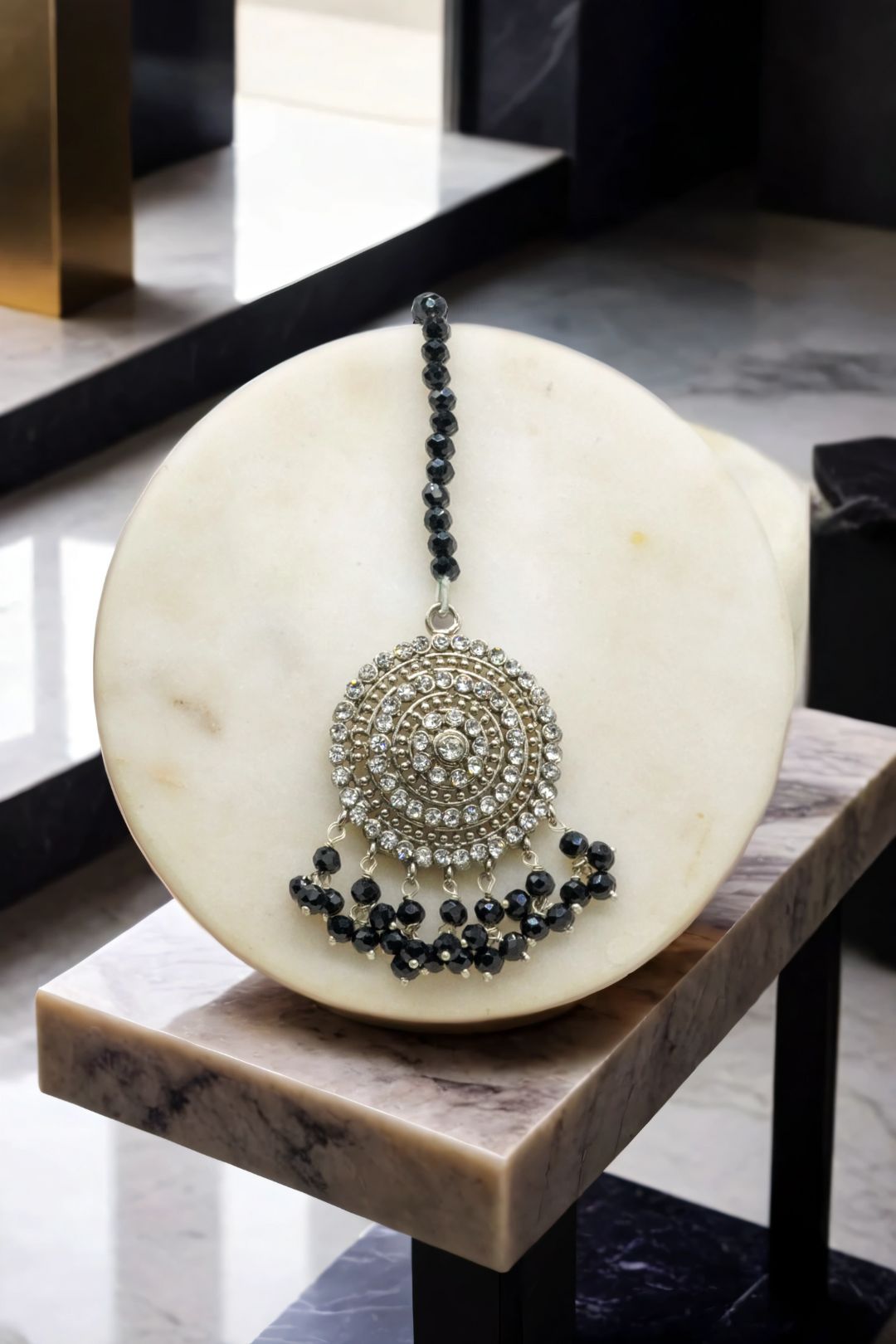 Silver Tabiha Maang Tikka with black beads, designed to match the Jhumka earrings in the Pakistani jewelry set.