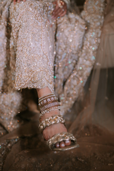 Soha artisan crafted bridal statement ankle set for Desi brides in antique gold and pearl with white stones