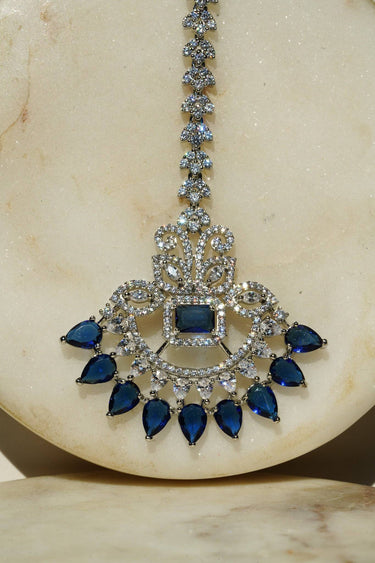 Close-up of the Inaury Isata oversized rhodium-plated maang tikka with sapphire blue and white AD stones – South Asian bridal headpiece