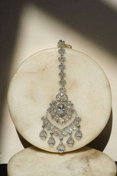 Close-up of the oversized Rhodium plated American Diamond Maang Tikka with white crystal teardrop dangles