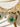 Close-up of green Purvi Diamante Necklace - Bridal Indian Jewelry with gold plating and sparkling stones for bridal wear.