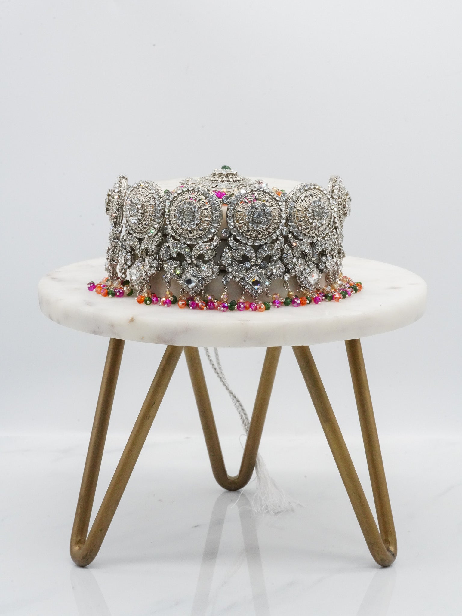 Silver Namar Choker Necklace Set with vibrant multicolor beads and CZ stones, displayed on marble and brass stand.