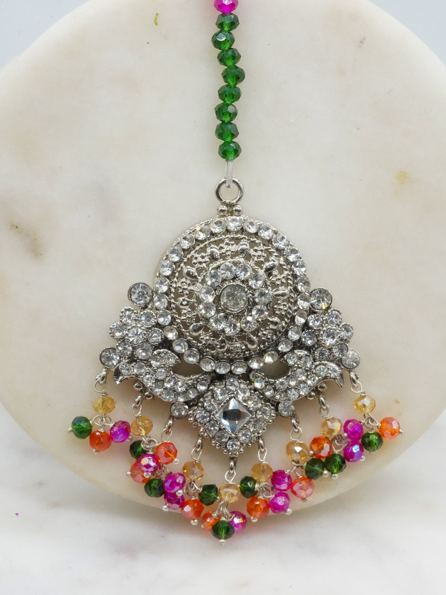 Close-up of maang tikka from Namar Necklace Set with colorful beads and detailed CZ stonework.