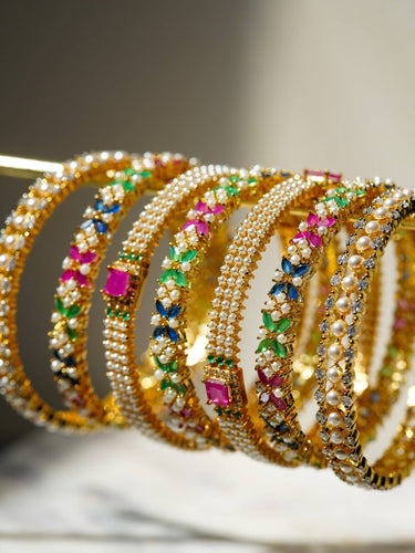 Close-up of Anayasa Gold Plated Multicolor Bangle Set showcasing vibrant CZ stones in floral patterns, perfect for festive jewelry collections.