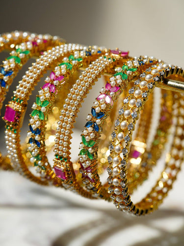 Detailed shot of Anayasa Multicolor Gold Plated Bangles with pearl and CZ embellishments, ideal for traditional and bridal accessories.