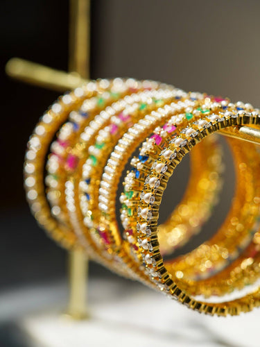 Side view of Anayasa Gold Plated Bangle Set with shimmering multicolor AD stones, highlighting the detailed craftsmanship and gold finish.