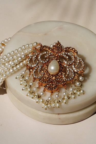 Detailed view of Ira - Chandbali maang tikka in pearl finish, showcasing teardrop pearl centerpiece and delicate pearl fringe.