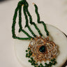 Ira - Chandbali Set in green bead variant with emerald green teardrop stone, gold filigree, and shimmering CZ stones.