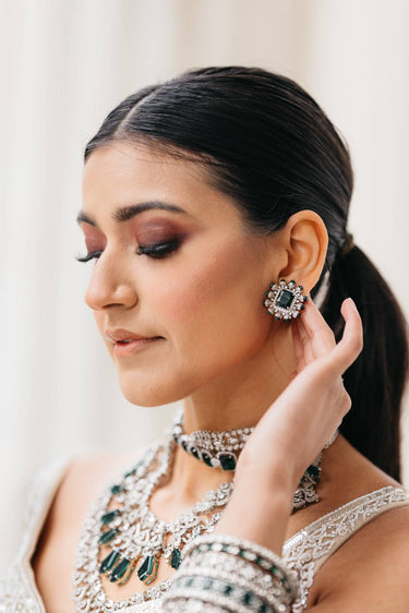 Ashma Bridal Set - Multilayer rhodium-plated silver finish with emerald green stones, including choker and multi-layered necklace.
