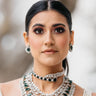 Ashma Bridal Set - Multilayer rhodium-plated silver finish with emerald green stones, including choker and multi-layered necklace.