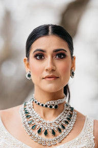 Ashma Bridal Set - Multilayer rhodium-plated silver finish with emerald green stones, including choker and multi-layered necklace.