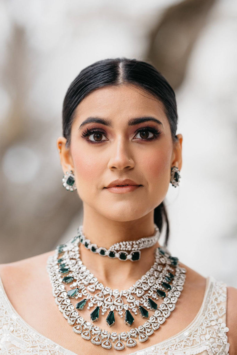 Ashma Bridal Set - Multilayer rhodium-plated silver finish with emerald green stones, including choker and multi-layered necklace.