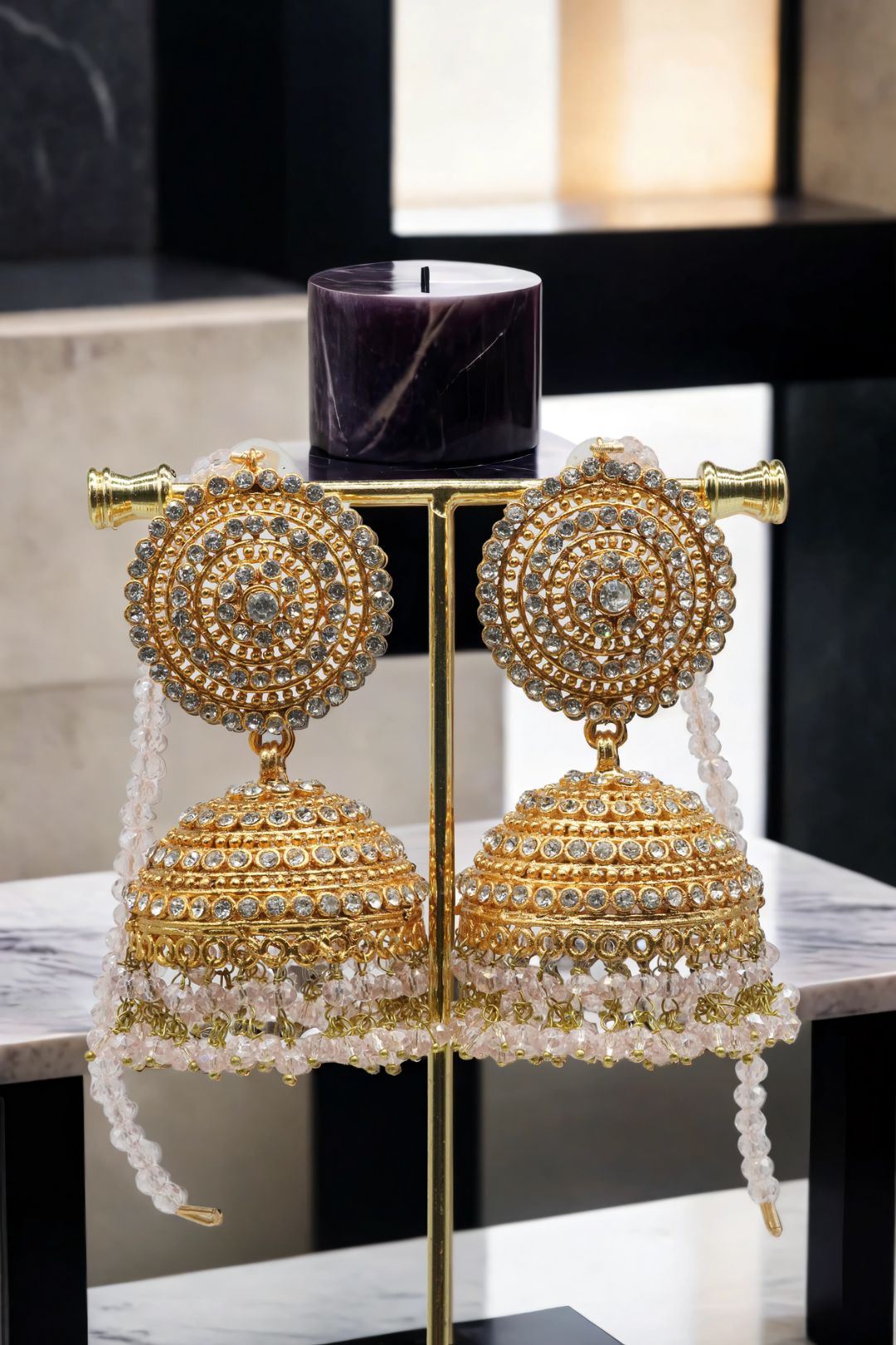 Gold Tabiha Jhumka Earrings with white crystal strands, a luxurious piece in the Pakistani jewelry set collection.