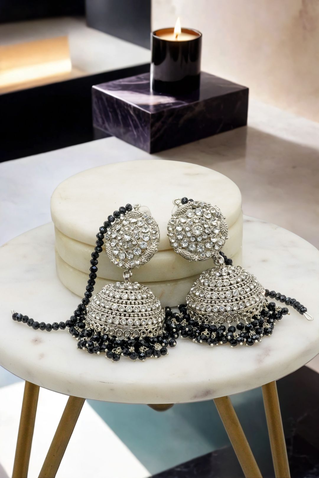 Silver Tabiha Jhumka Earrings with black beads, laid flat to highlight intricate detailing in the jewelry set.