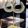 Noor Chandbali Hoop Earrings in silver-tone with white pearls, showcasing South Asian elegance on a gold display stand.