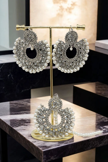 Laila Chandbali Earrings and Maang Tikka Set in antique gold on a gold stand, ideal for weddings and traditional occasions.