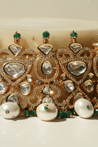 Kainat bridal choker necklace set with moissanite polki stones, green and pearl accents, and matching earrings