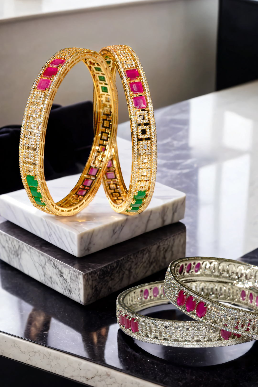 Kyra dual-tone bangle set with rhodium and gold plating, ruby and green stones, and white pave stones