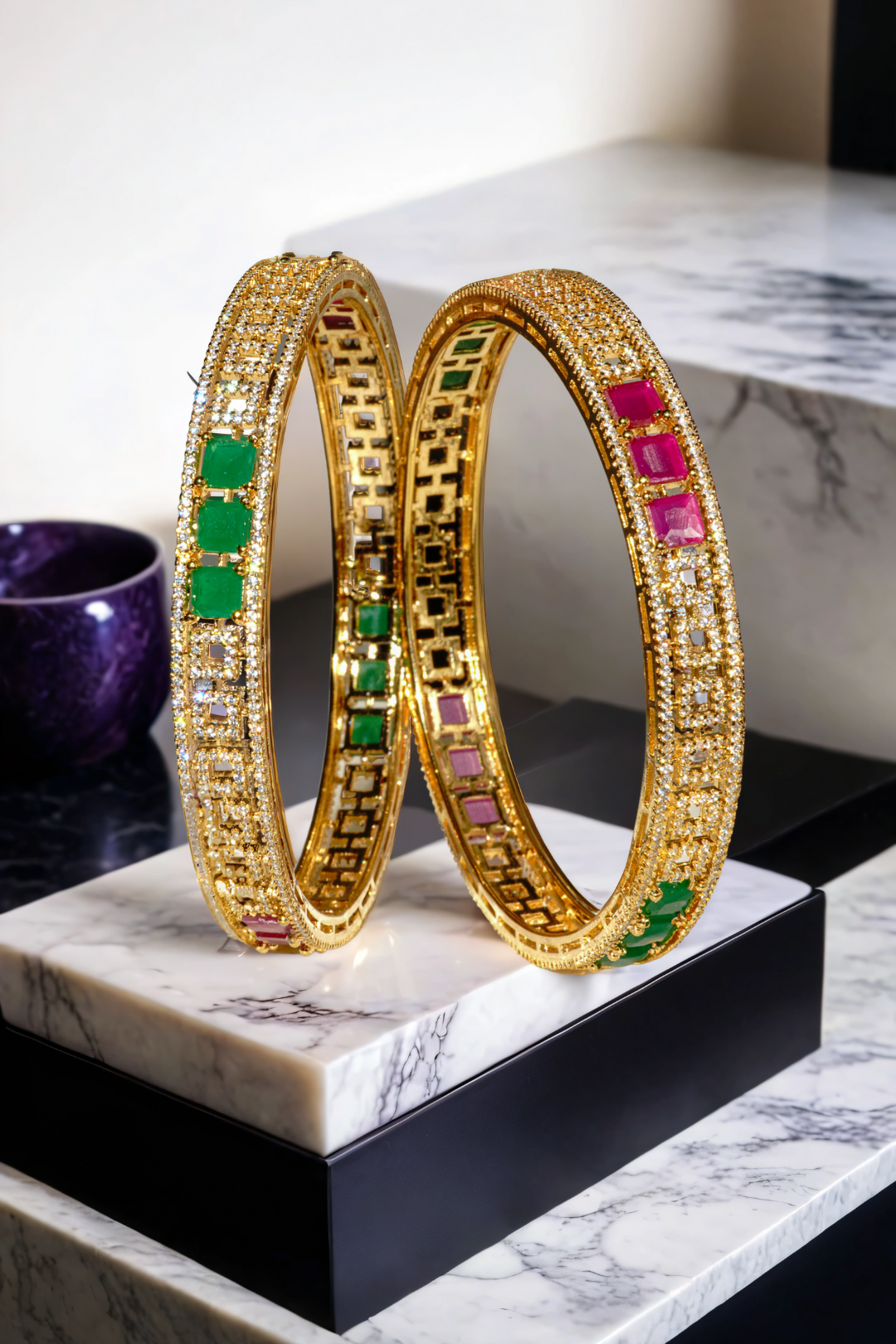 Kyra dual-tone bangle set with rhodium and gold plating, ruby and green stones, and white pave stones