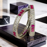 Kyra dual-tone bangle set with rhodium and gold plating, ruby and green stones, and white pave stones