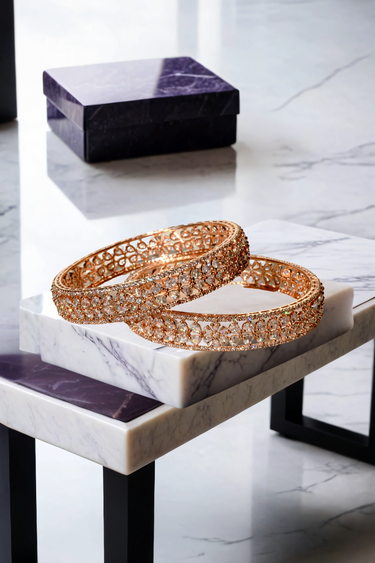 Stylish Myra Rose Gold AD Bangles set with detailed floral petal cutwork and white stone rims, placed on marble decor.