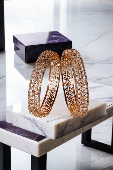 Myra Bangles Set - Rose Gold AD Bangles with intricate floral petal design, shown upright on a marble and purple platform.