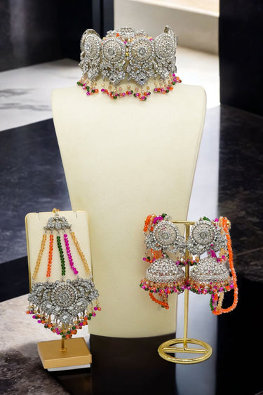 Display of Namar Choker Necklace Set in silver with colorful beads, including earrings and maang tikka on jewelry stands.