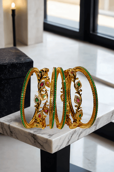 Norea 6-piece gold-plated bangle set with green, ruby, and white stones and intricate floral and vine motifs