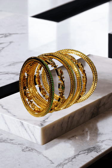 Norea 6-piece gold-plated bangle set with green, ruby, and white stones and intricate floral and vine motifs
