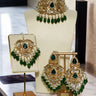 Noreen Choker Necklace Set - Elegant Pakistani Bridal Jewels in gold with green teardrop stones, displayed with matching earrings and tikka.