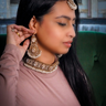 Model wearing Rimmie Artisan Crafted Choker Set with earrings and maang tikka, showcasing traditional Pakistani jewelry elegance.
