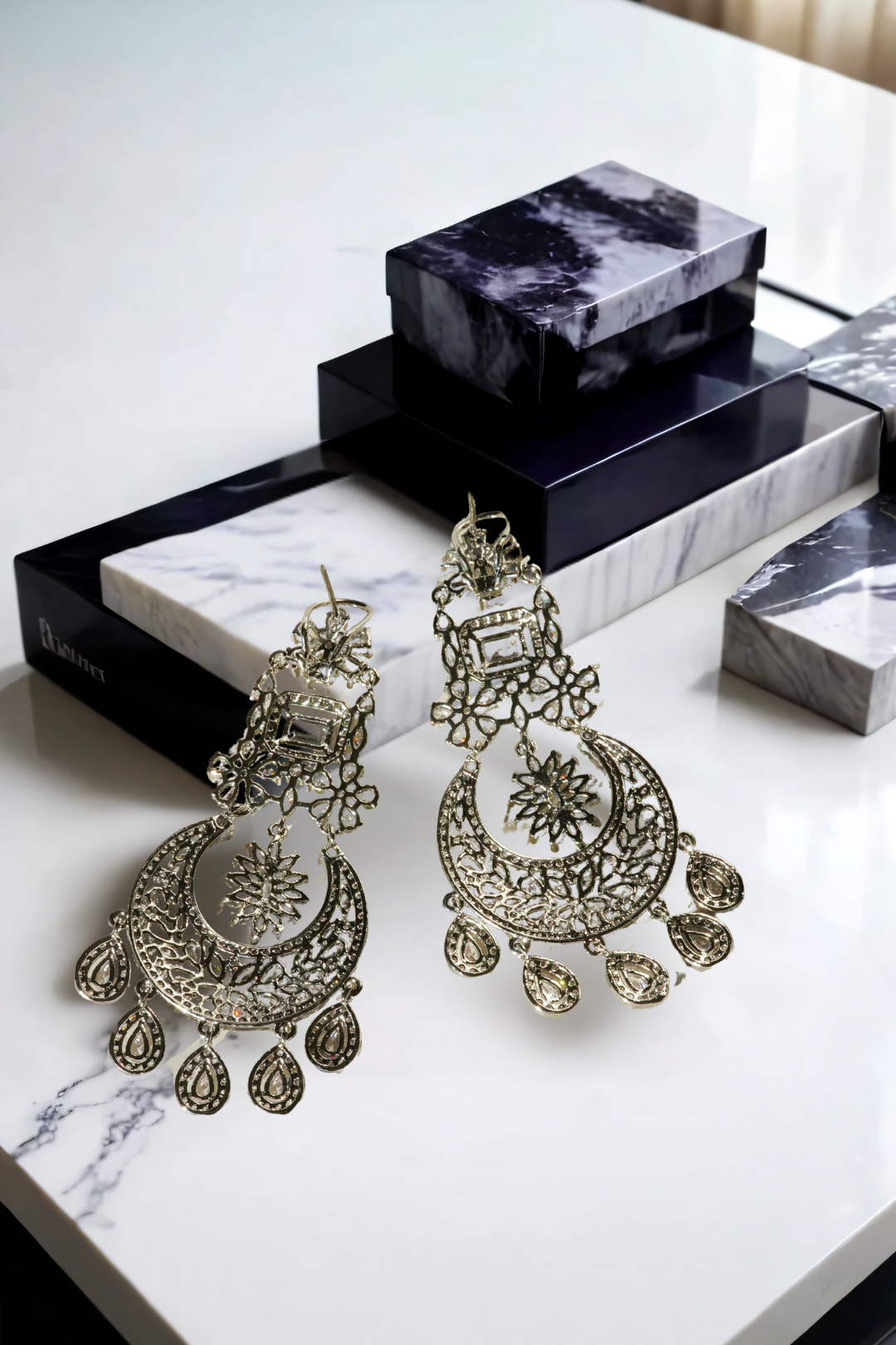 Samina chandelier earrings, rhodium-plated, white pavé stones, crescent design with teardrop charms, Indian jewelry