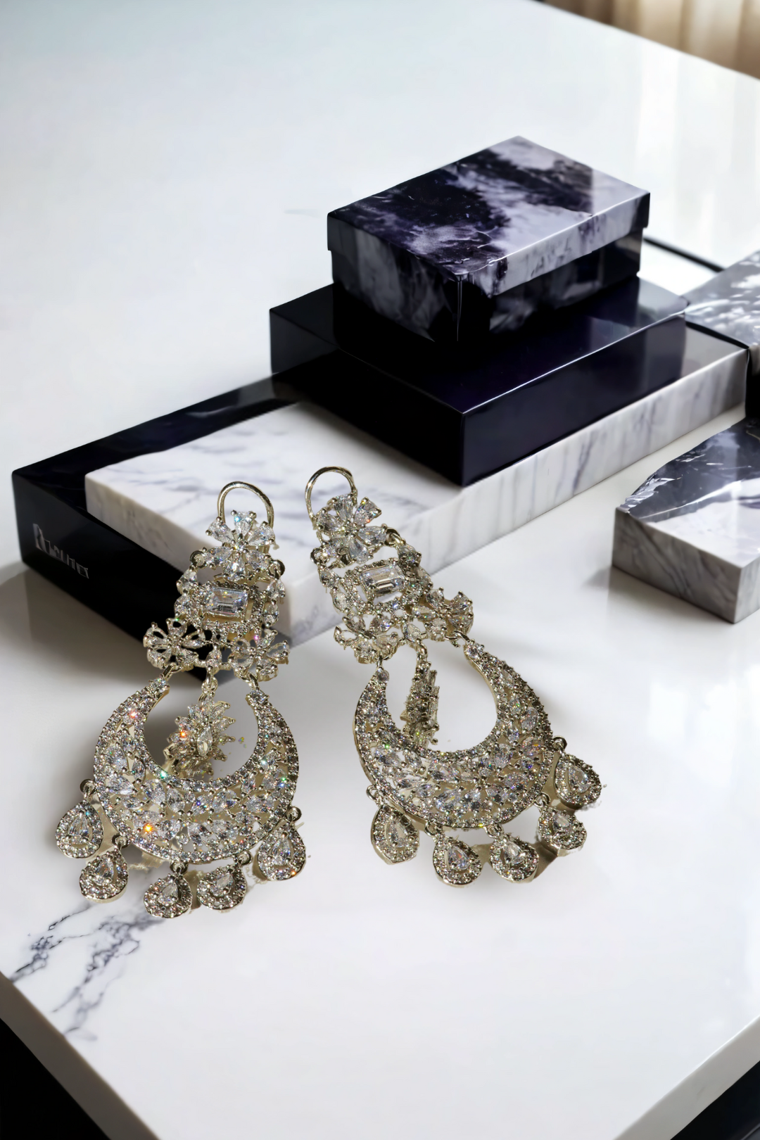 Samina chandelier earrings, rhodium-plated, white pavé stones, crescent design with teardrop charms, Indian jewelry