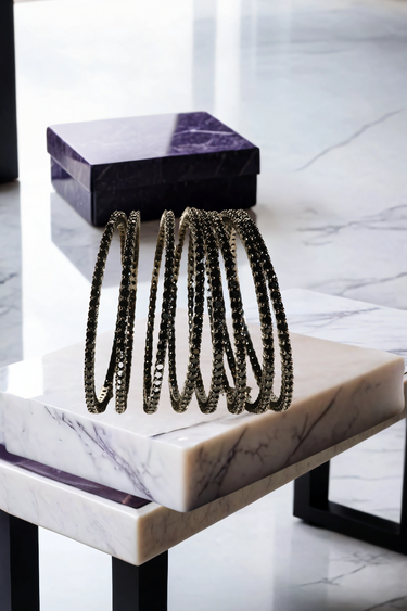 Simran Bangles - Set of 8 Choori Style Black Plated Bangles with Black Stones by Inaury, displayed on a marble surface with luxurious black detailing.