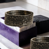 Simran Bangles - Set of 8 Choori Style Black Plated Bangles with Black Stones by Inaury, displayed on a marble surface with luxurious black detailing.