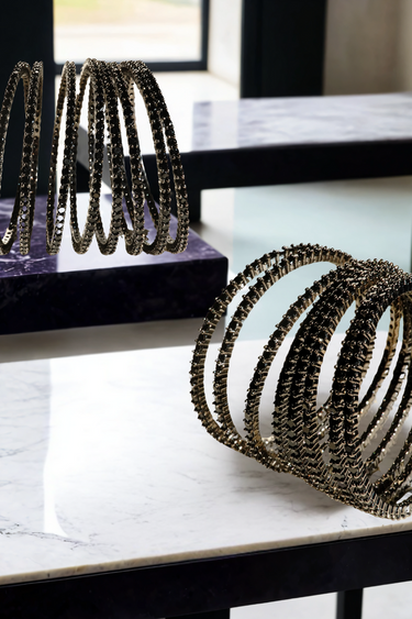 Simran Bangles - Set of 8 Choori Style Black Plated Bangles with Black Stones by Inaury, displayed on a marble surface with luxurious black detailing.