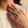 A woman wearing silver-toned adjustable baguette diamante statement ring with blush pink center stone - South Asian jewelry - Inaury